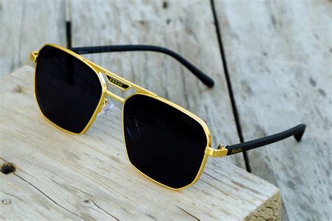 prada sunglasses black and gold.